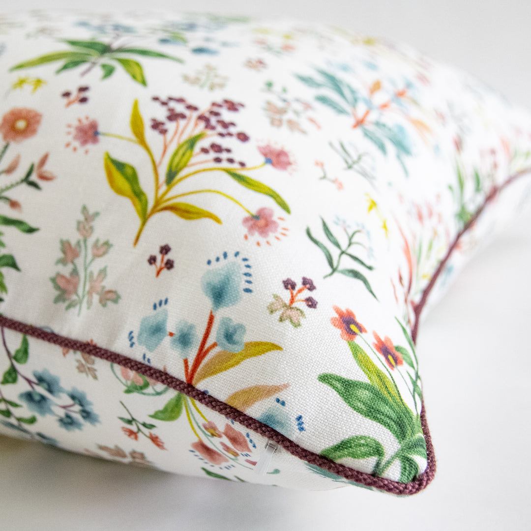 multicolor floral pillow with purple cording