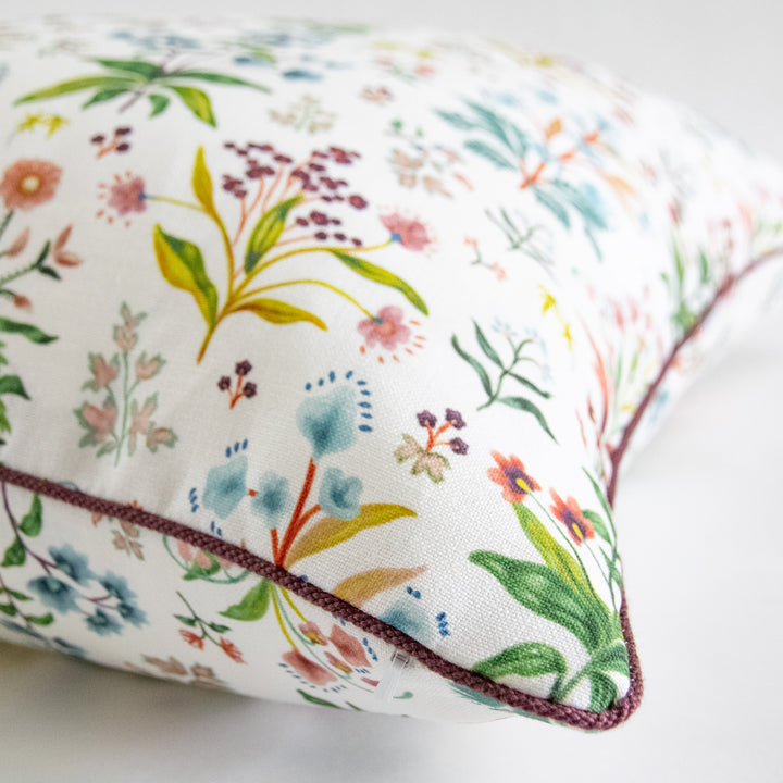 multicolor floral pillow with purple cording