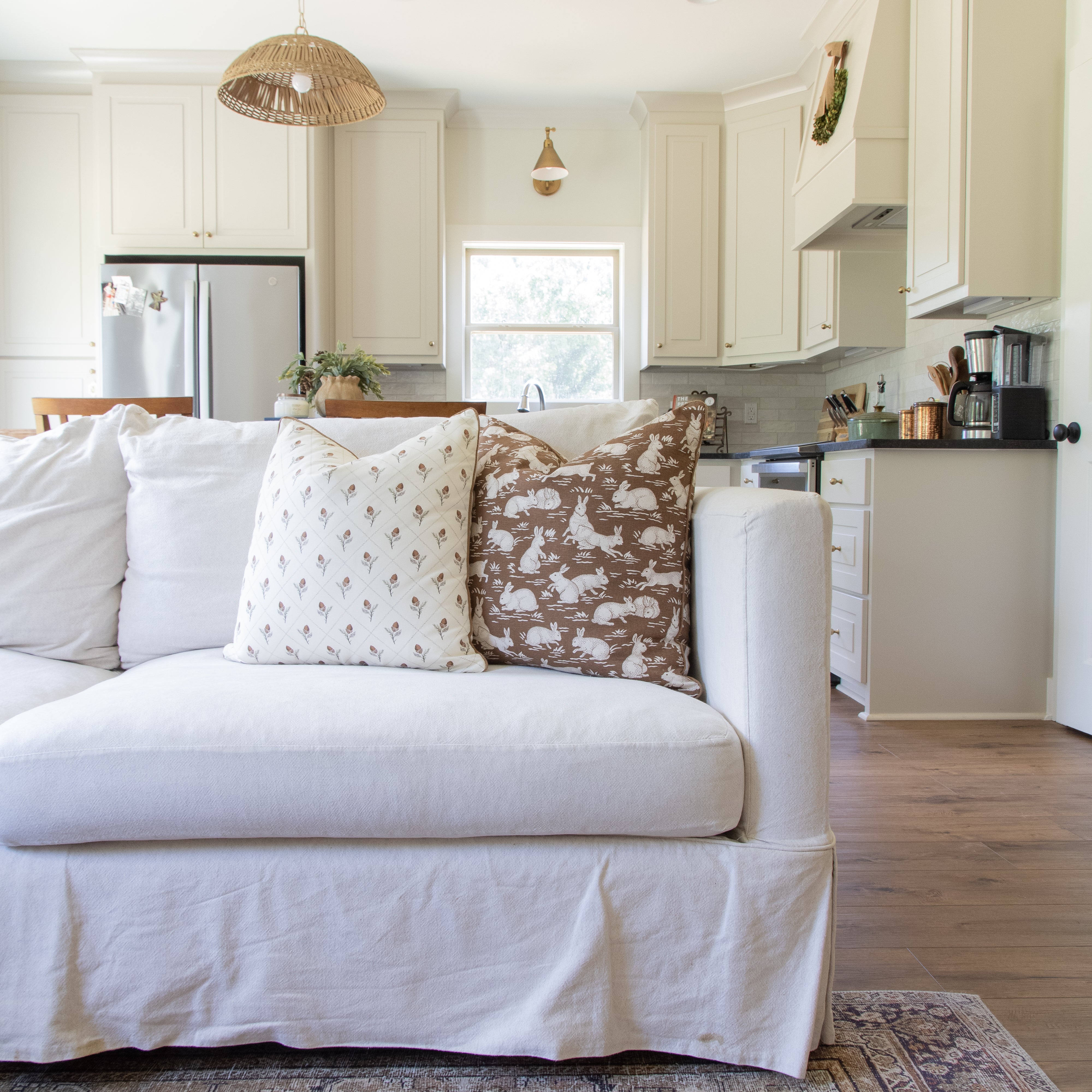 acorn pattern pillow paired with bunny rabbit pillow on cream sofa