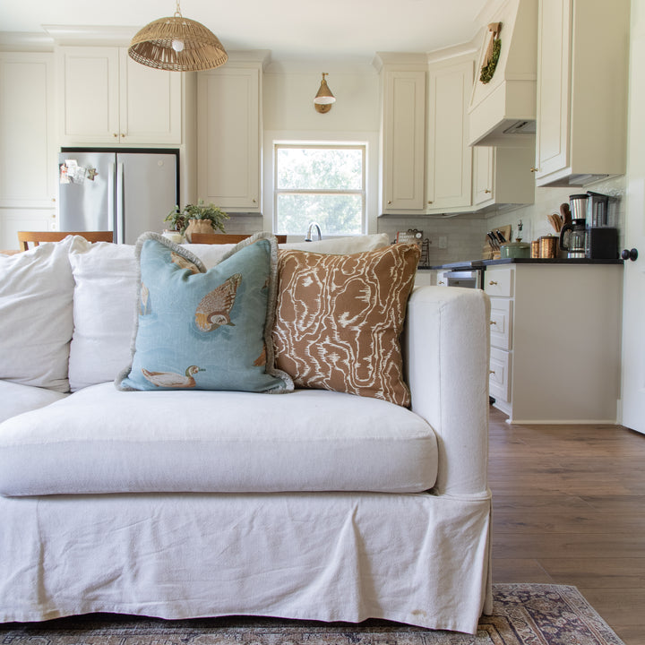 mulberry home pillow and Leah oconnell pillow on white sofa