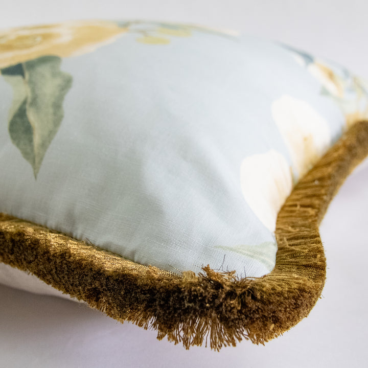blue and gold camellia floral pillow with brush fringe