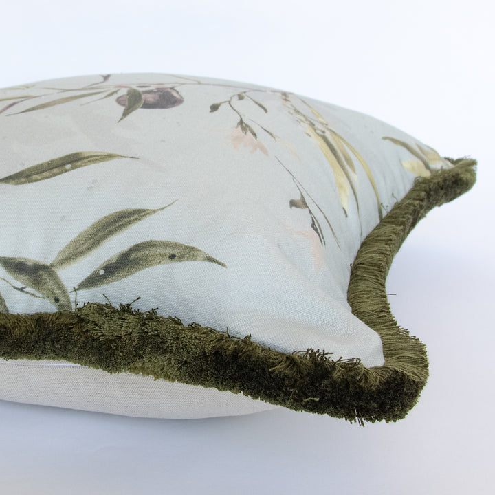 light blue watercolor botanical fig pillow with dark green brush fringe