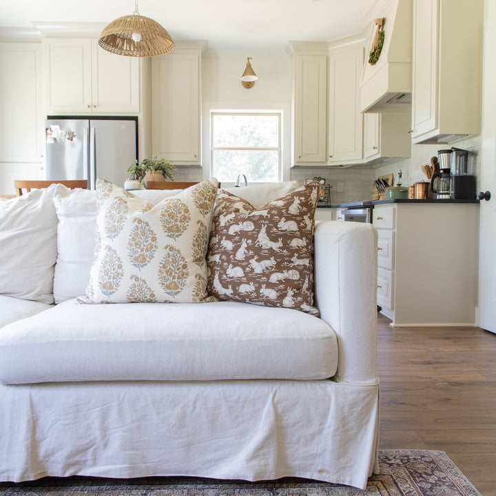 schumacher and namay samay pattern pillows on cream sofa in living room